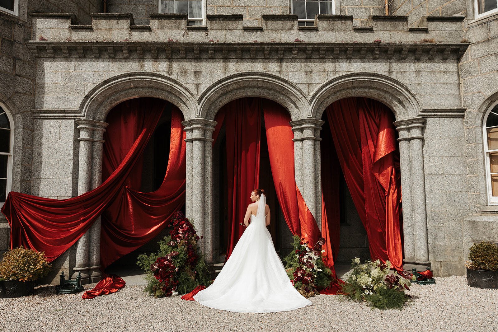 Bride with red draping Cluny castle 